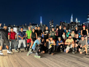 New York City inline skaters gathered with the Manhattan skyline behind them