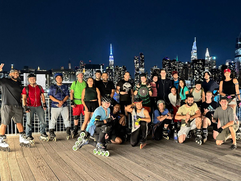New York City inline skaters gathered with the Manhattan skyline behind them