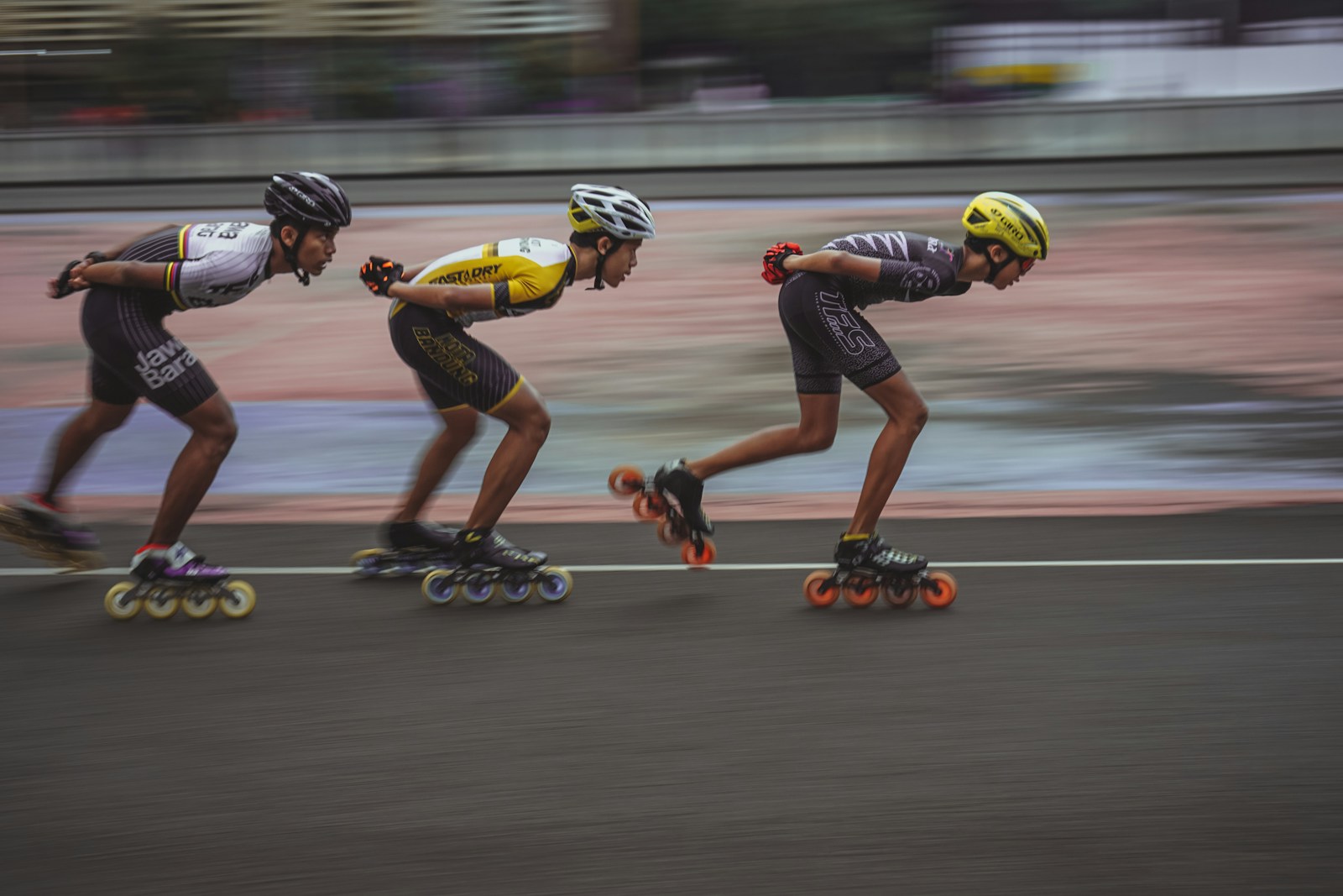 Inline speed skaters racing on an outdoor track