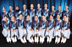 A synchronized skating team from Nottingham posing together on the ice